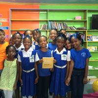 Filling the shelves with donated books in the library at Laborie Girls RC Primary School in St. Lucia. image